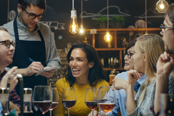 waiter taking orders from a group of friends